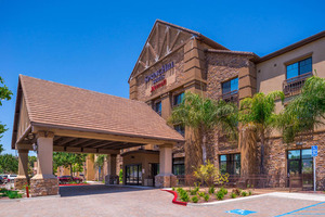 A scenic view of hotels in Temecula, nestled among rolling vineyards and lush landscapes. The hotels range from modern, luxurious resorts to charming boutique inns, all offering comfortable accommodations and amenities for guests. Nearby attractions include picturesque wineries, historic Old Town Temecula, and outdoor adventure spots.